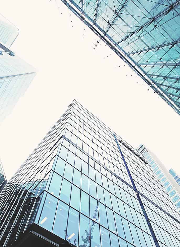 Looking up at the top of modern, tall buildings
