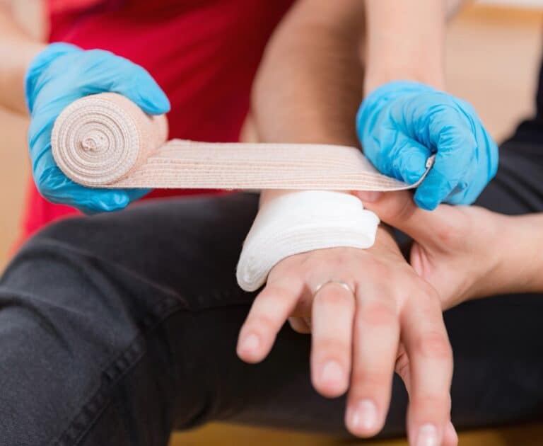 Medic applying bandage to child's arm