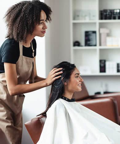 Hair stylist in the salon doing a woman's hair.
